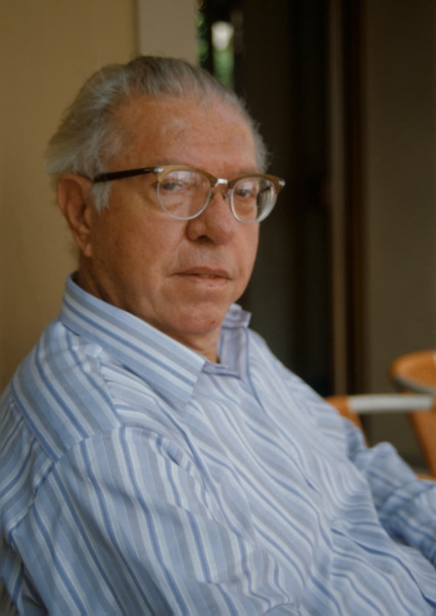 Fred Hoyle, an older man in glasses and a striped shirt.